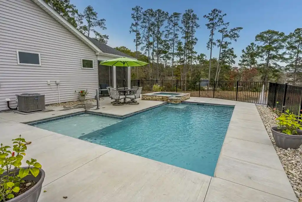 Lux project custom pool and spa with waterfall feature by the lake