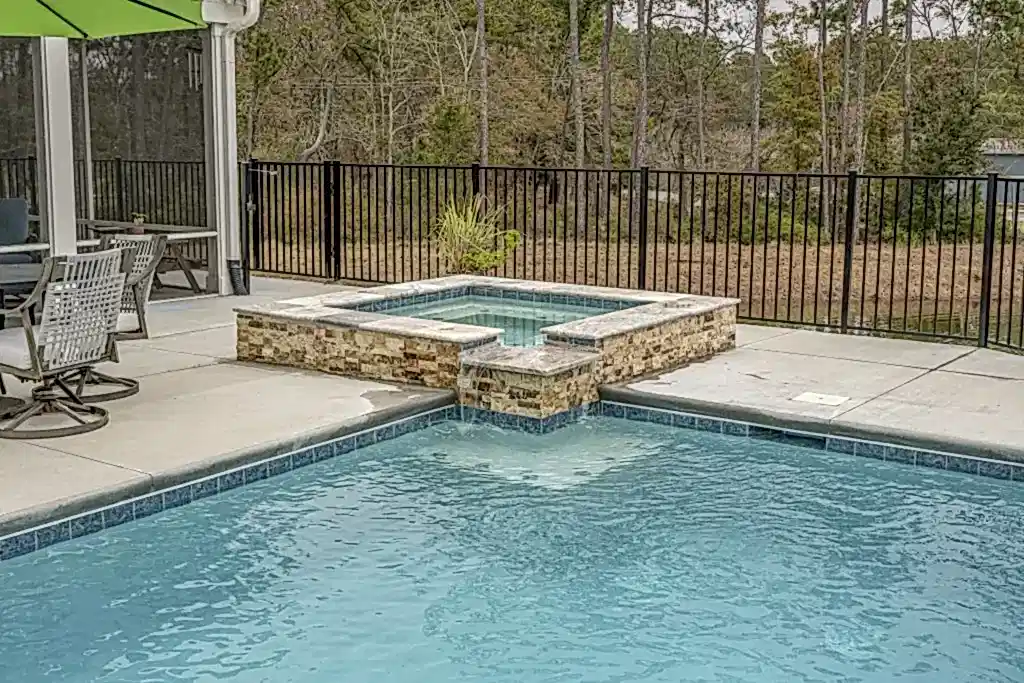 Lux project custom pool with waterfall feature by the lake