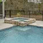Lux project custom pool with waterfall feature by the lake