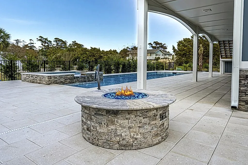 Lux Project 7 custom fireplace beside pool and spa