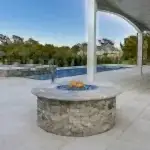 Lux Project 7 custom fireplace beside pool and spa